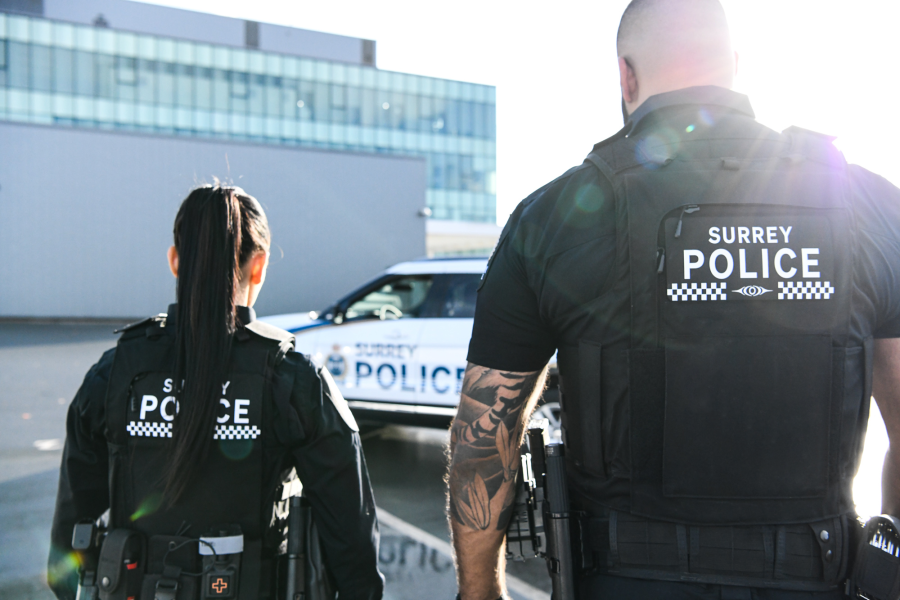 Jas and Madison walking towards police vehicle