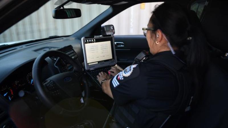 SPS officer works on her MDT in her vehicle 