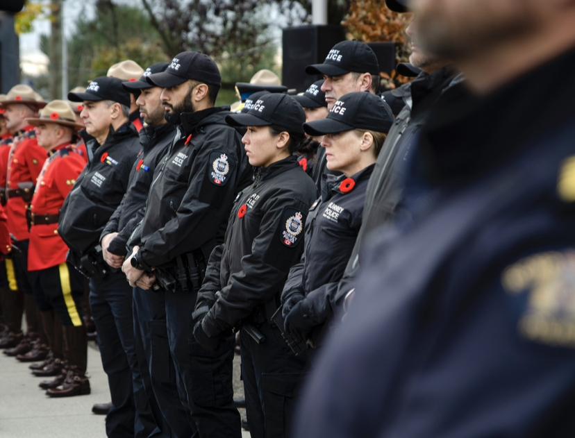 Officers stand in line at Remembrance Day celebrations in uniform